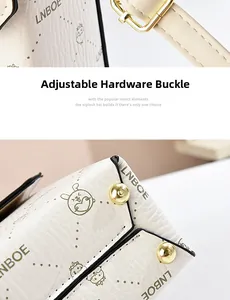 Detail of lychee textured leather bag with gold hardware buckles and cartoon prints