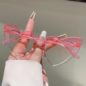 Close-up of translucent pink heart-shaped kids sunglasses with clear lenses