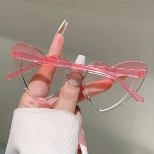 Detail of pink translucent heart-shaped sunglasses frame with clear lenses for kids