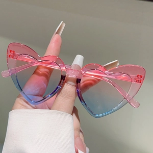 Detail showing heart-shaped kids sunglasses with pink to blue gradient lenses