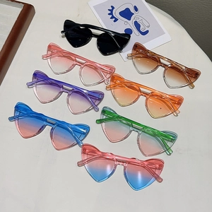 Colorful heart-shaped sunglasses for kids in various cute colors on a white surface