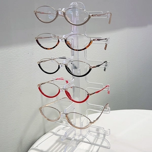 Multi-colored retro cat-eye anti-blue light glasses displayed on a transparent stand