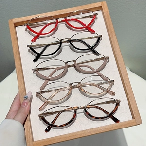Detail view of vintage blue light glasses frames in red, black, beige, and tortoiseshell