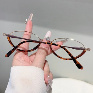 Close-up of retro amber tortoiseshell frame glasses with elegant gold metal temples