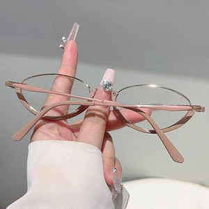 Detail of vintage amber-toned glasses frame with pink accents and sleek metal temples