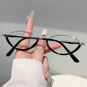 Detailed close-up of retro oval frame glasses with gold and black metal accents