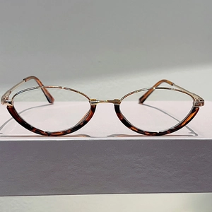 Detail of vintage cat-eye glasses with amber tortoiseshell rims and gold metal temples