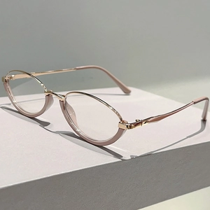 Detail of elegant pink acetate and rose gold metal temples on oval light blocking glasses
