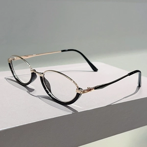 Detail view of cat-eye glasses showing gold metal temples and black composite frames