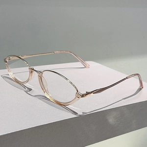 Detail of pink transparent frames with rose gold metal temples on a white stand