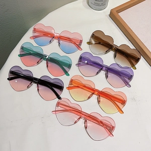 Detailed view of heart-shaped rimless sunglasses in seven vibrant gradient color combinations