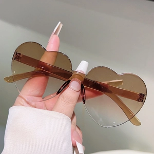 Close-up of heart-shaped rimless sunglasses with brown gradient lenses for kids