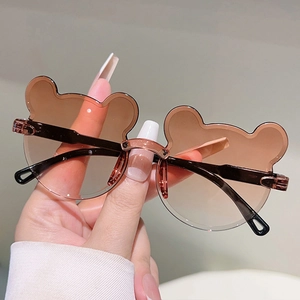 Détail de lunettes de soleil ours pour enfants avec verres dégradés et pont métallique