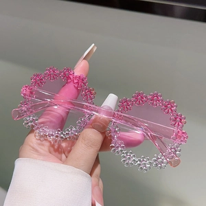 Close-up of pink gradient floral daisy round frame sunglasses for kids made of resin