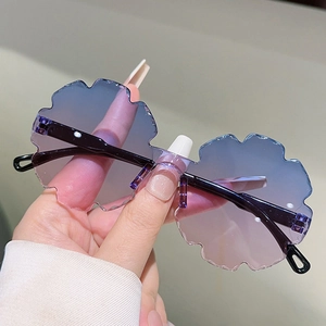 Detail of blue and pink gradient rimless lenses with scalloped wavy edges for kids