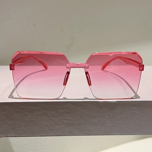 Close-up of pink gradient jelly lenses and irregular geometric rimless sunglasses frame