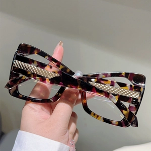 Close-up of cat-eye frames with multicolored tortoiseshell texture and gold metal accents