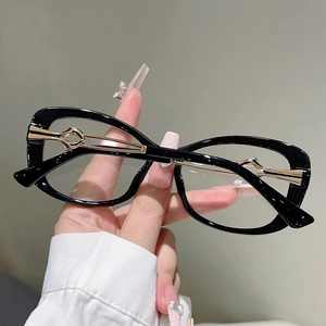 Detail of gold hollow metal temples on black cat-eye glasses with chic geometric design