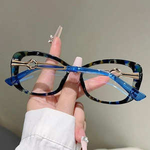 Detail of tortoise frame and hollow gold metal temple on retro rectangle glasses