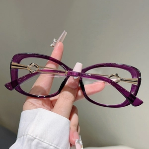 Detailed view of hollowed metal temples and purple frame of fashion blue light glasses