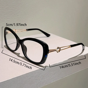 Detail view of cat eye glasses showing golden metal temples with heart hollow-out design