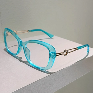 Close-up of stylish blue eyeglass frames with artistic twisted gold metal temples