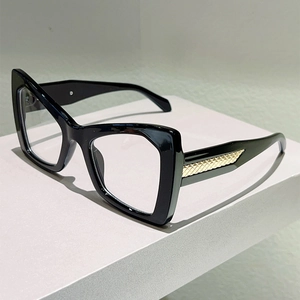 Detail of cat-eye frames with gold woven metal texture on temples for a stylish look