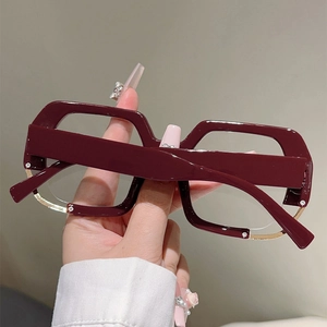 Detail of burgundy oversized square frames with metal trim and rhinestone accents