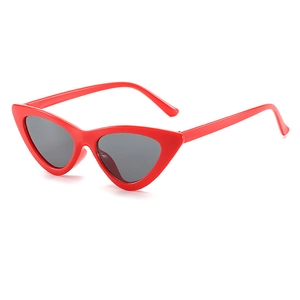 Detail of red cat eye sunglasses with high-gloss resin frame and dark lenses