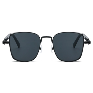 Close-up of steampunk metal spring hinges and industrial screw details on black square sunglasses