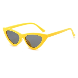 Detail view of stylish yellow cat eye sunglasses with grey lenses on white background