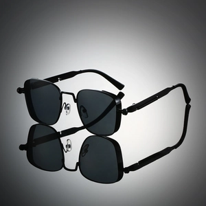Detailed view of square black sunglasses with metal spring hinges and mirror reflection