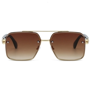 Macro detail of gold metal double bridge aviator sunglasses with brown gradient lenses