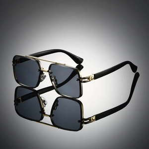 Detail of gold metal double bridge frame with textured engraving and dark grey lenses