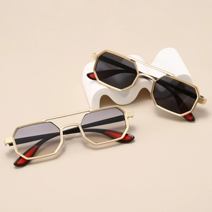 Hexagonal metal sunglasses with double bridge and gradient lenses on beige display