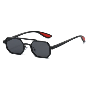 Detail of hexagonal sunglasses with double bridge and red accents on temple tips