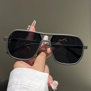 Detail of matte gray double-bridge sunglasses with dark square lenses and modern frame design