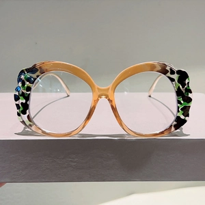 Detail view of round leopard print eyeglass frames with unique camouflage color patterns