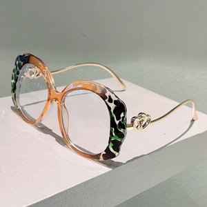Macro detail of irregular leopard print frame with heart shaped metal hinges