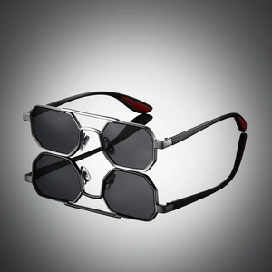 Detail of silver hexagonal metal sunglasses with double bridge and dark grey lenses