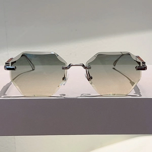 Detail of rimless hexagonal sunglasses with gradient lenses and silver metal bridge