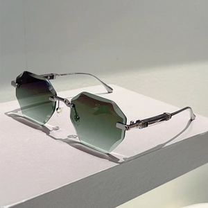 Detail of rimless hexagonal gradient green sunglasses with silver metal temples