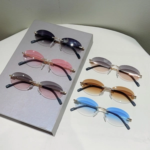 Detail of colorful rimless oval sunglasses with gradient lenses and slim gold metal temples