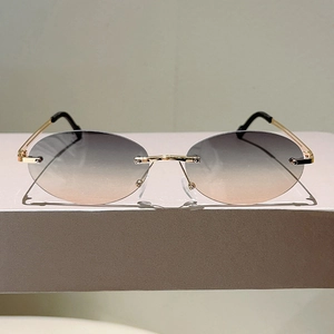 Detail view of rimless gradient lenses with sleek gold metal temples and black tips