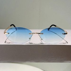 Detail of rimless oval sunglasses with blue gradient lenses and slim gold metal temples