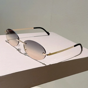 Detail view of rimless oval sunglasses with gradient lenses and slim gold metal temples