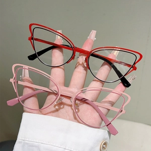 Detail of cat eye glasses showing dual-layer metal frame and bicolor butterfly design