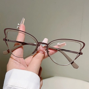 Detailed view of dual-layer cat-eye metal frames in deep brown with slim temples