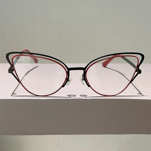 Close-up of butterfly frame glasses with dual-layer black and red metal design