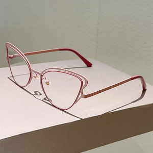 Detail of pink cat-eye glasses frame with layered hollow metal design and stylish finish